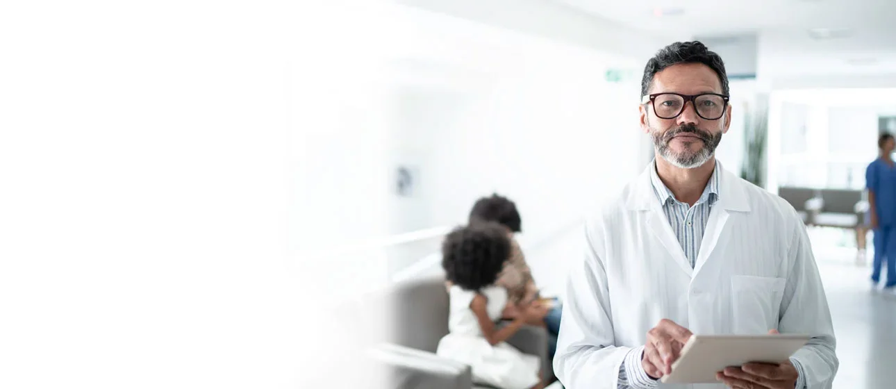 Doctor at hospital checking reports in the tablet.